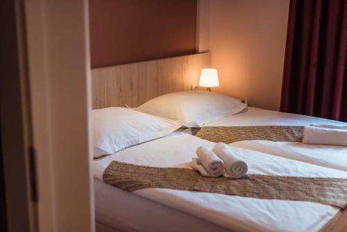 a hotel room with two towels on a bed at Boutique Hostel Livia in Metković