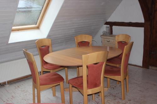 a wooden table and chairs in a room at Bio Erlebnishof Grittel in Grittel