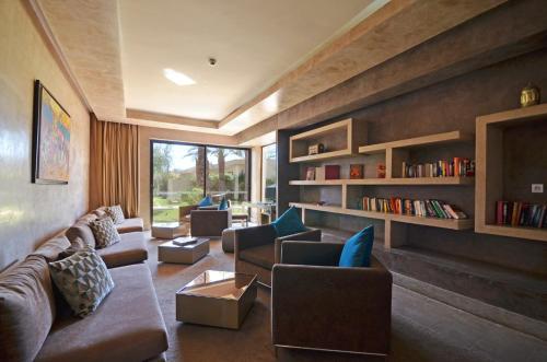 a living room with couches and bookshelves at Sirayane Boutique Hotel & Spa Marrakech in Marrakech