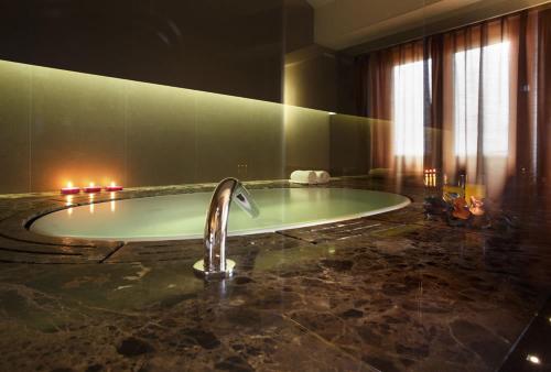 a bathroom with a bath tub with a sink at Villa Luisa in Todi