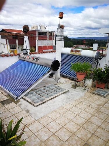 a rooftop with blue solar panels on a building at Hotel Chalet in Chichicastenango