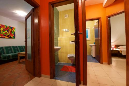 a bathroom with a toilet and a glass shower at Pansion HRGA in Vodice