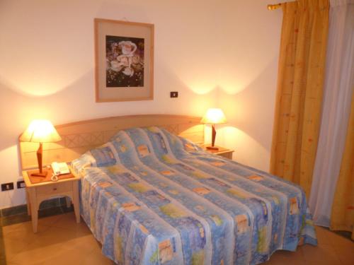 Säng eller sängar i ett rum på Logaina Sharm Resort