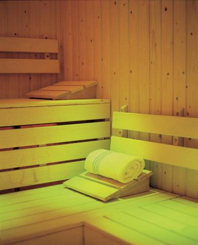 a sauna with a towel and a book in it at Knights Hill Hotel & Spa in Kings Lynn
