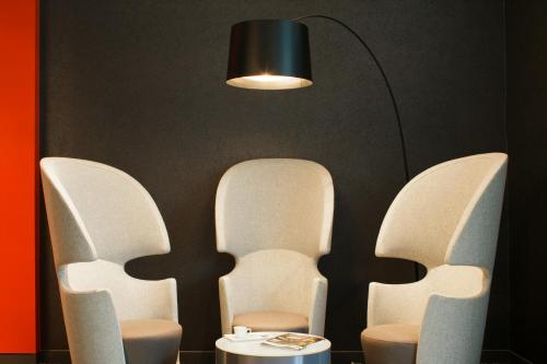 two chairs with a table and a lamp at ibis London Blackfriars in London