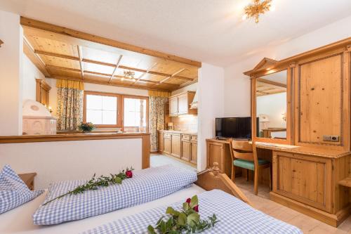a kitchen and living room with two beds at Pension Margretenhof in Fulpmes