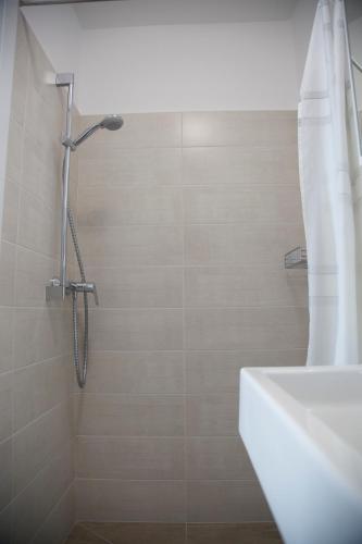 a bathroom with a shower with a tub and a sink at Gästehaus Pusztablick in Illmitz