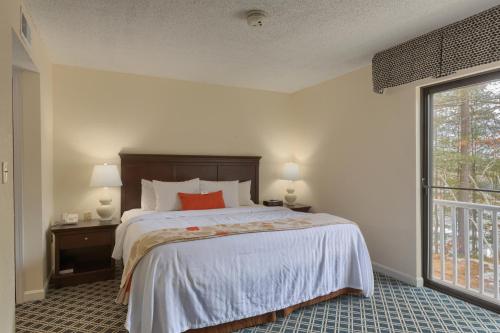 a bedroom with a bed and a large window at Residences at Daniel Webster in Merrimack