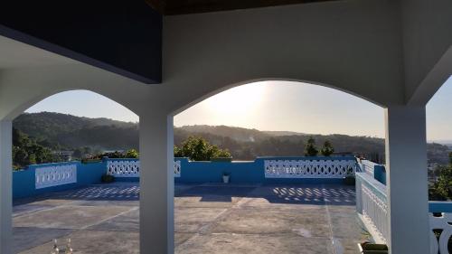 a view from the porch of a house with blue walls at Bailey's Bed and Breakfast in Runaway Bay