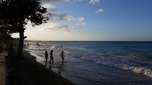 a group of people walking on the beach at Bailey's Bed and Breakfast in Runaway Bay