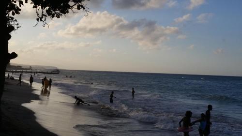 a group of people standing on the beach at Bailey's Bed and Breakfast in Runaway Bay