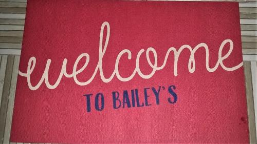 a red towel with the word welcome to babies at Bailey's Bed and Breakfast in Runaway Bay