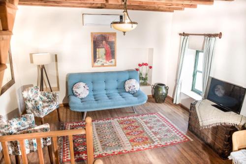 a living room with a blue couch and a rug at Two Stone Homes Asteria in Marmaris