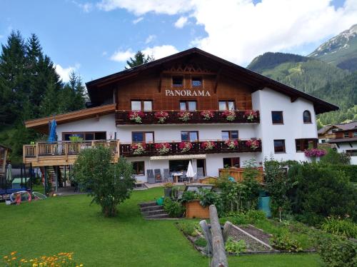 a building with flowers on the front of it at Haus Panorama in Lermoos