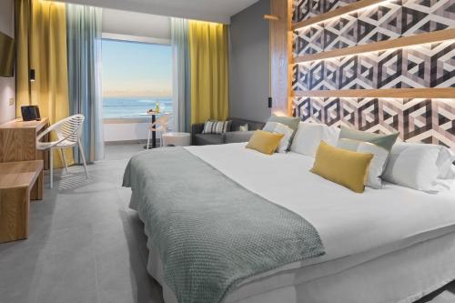 a bedroom with a large bed with a view of the ocean at Hotel Atlantic Mirage Suites & SPA - ADULTS ONLY in Puerto de la Cruz