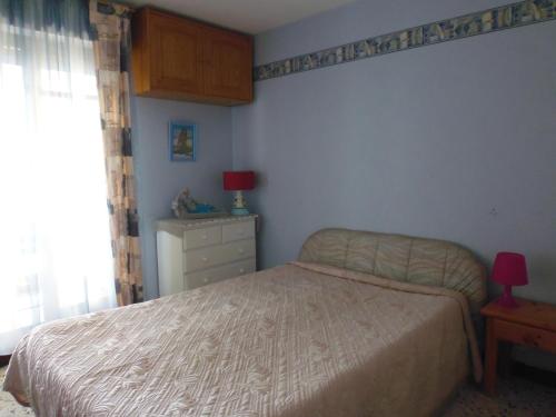 a bedroom with a bed and a dresser and a window at T2 Superbe vue port et mer in La Grande-Motte