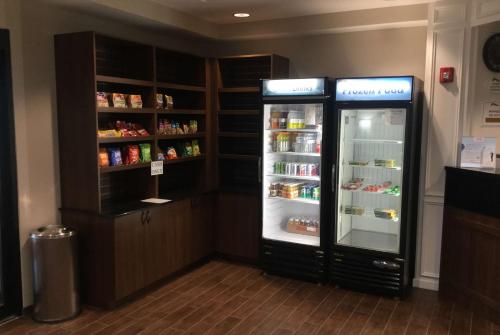 a kitchen with two refrigerators with food inside of it at Baymont by Wyndham Page Lake Powell in Page