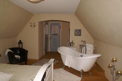 a bathroom with a bath tub in a attic at Landhaus Grinnerhof in Mehlingen