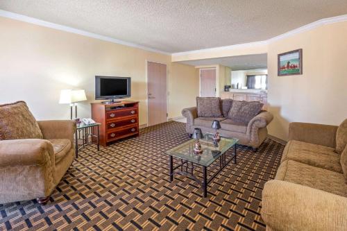 a living room with furniture and a flat screen tv at Extend-a-Suites - Extended Stay, I-40 Amarillo West in Amarillo