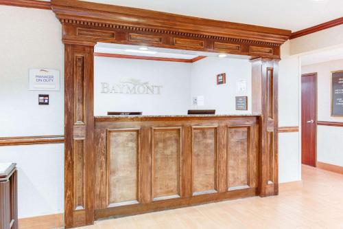 a wooden door in a building with a sign on it at Baymont by Wyndham Kalamazoo West in Kalamazoo