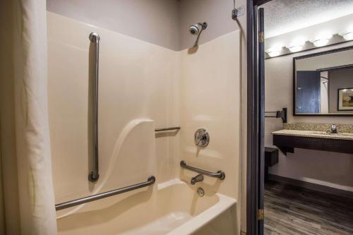 a bathroom with a tub and a sink at Baymont by Wyndham Madison West/Middleton WI West in Madison