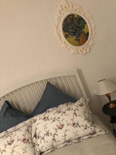 a bed with a pillow and a mirror on the wall at Casa Sofì in Tolentino