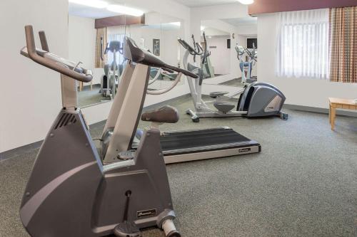 a gym with two tread machines and a treadmill at Baymont by Wyndham Janesville in Janesville
