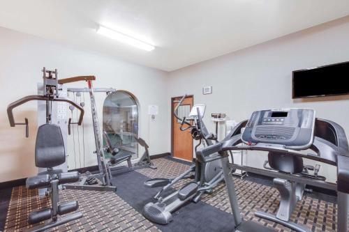 a gym with tread machines and a flat screen tv at Baymont by Wyndham Wheeler in Wheeler