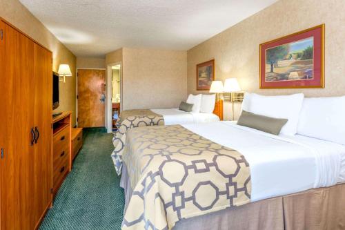a hotel room with two beds and a television at Baymont by Wyndham Amarillo East in Amarillo