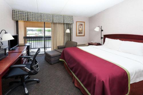 A bed or beds in a room at Baymont by Wyndham Michigan City