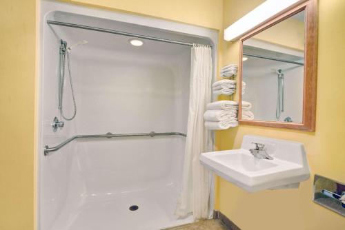 a white bathroom with a sink and a shower at Baymont by Wyndham Washington Court House in Jeffersonville