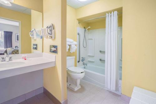 a bathroom with a sink and a toilet and a shower at Baymont by Wyndham Warrenton in Warrenton