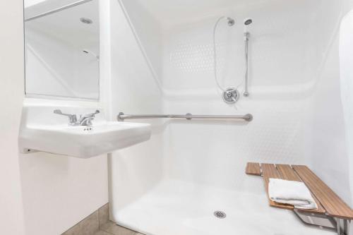 a white bathroom with a sink and a shower at Baymont by Wyndham Yreka in Yreka