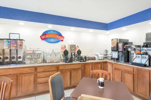 a fast food restaurant with a counter with a table at Baymont by Wyndham Boone in Boone