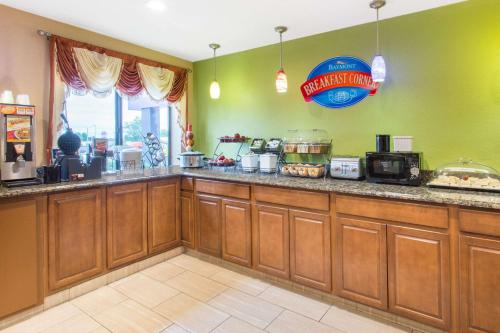 a fast food kitchen with a counter top with aperature at Baymont by Wyndham Waukesha in Waukesha