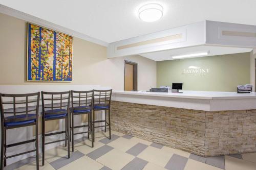 a bar in a dental office with stools at Baymont by Wyndham Ames in Ames