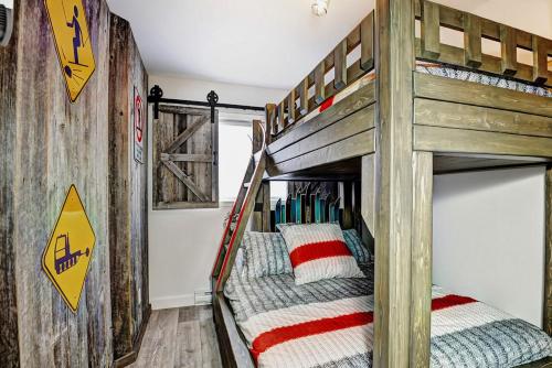 a bunk bed in a room with two bunk beds at Condo 304 33 Chemin du Hameau by Les Chalets Alpins in Stoneham