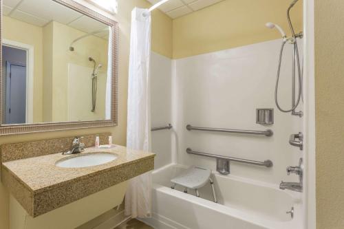 a bathroom with a sink and a tub and a shower at Baymont by Wyndham Cornelia in Cornelia