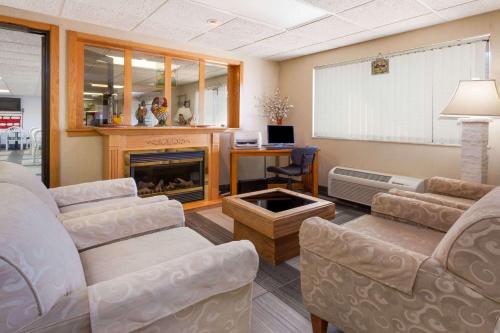 a living room with two couches and a fireplace at Baymont by Wyndham Midland in Midland
