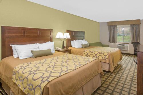 a hotel room with two beds and a window at Baymont by Wyndham Ames in Ames