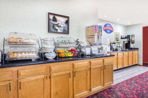 a kitchen with a counter with food on it at Baymont by Wyndham Bowling Green in Bowling Green
