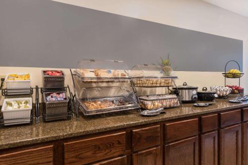 a kitchen counter with trays of food on it at Baymont by Wyndham Hot Springs in Hot Springs