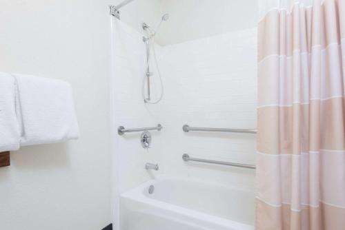 a bathroom with a shower and a white tub at Baymont by Wyndham Santa Fe in Santa Fe