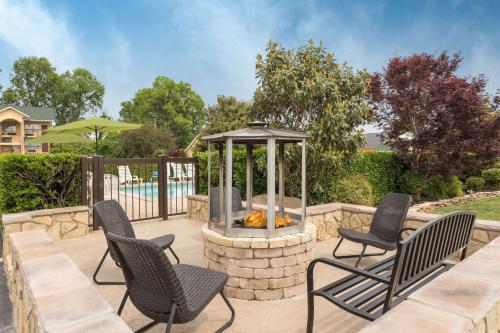 a patio with two chairs and a fire pit at Baymont by Wyndham Sevierville Pigeon Forge in Sevierville