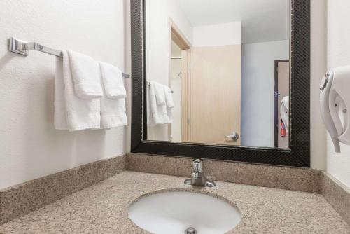 a bathroom with a sink and a mirror at Baymont by Wyndham Santa Fe in Santa Fe