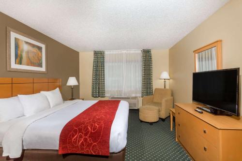 a hotel room with a bed and a flat screen tv at Baymont by Wyndham Billings in Billings