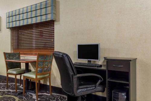 an office with a desk with a computer and chairs at Baymont by Wyndham Billings in Billings