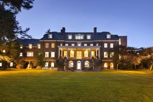 a large house with a large lawn in front of it at Ivey Spencer Leadership Centre in London