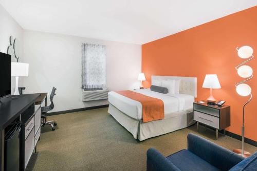 a hotel room with a bed and a tv at Howard Johnson by Wyndham Quincy/ Boston in Quincy