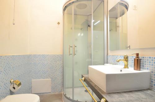 a bathroom with a sink and a shower at S'Ommu Ezza in Narbolia